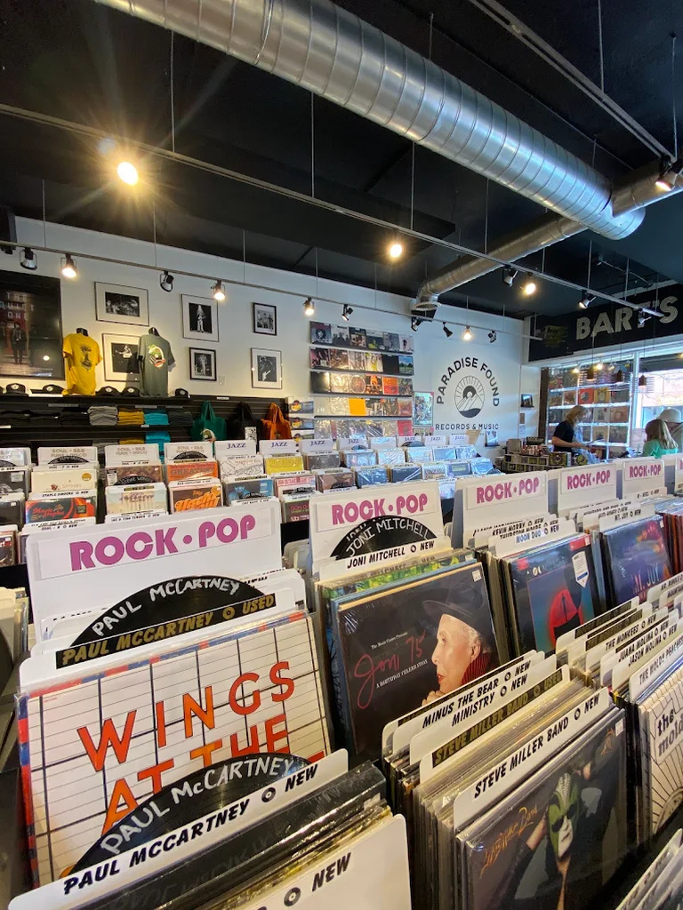 Genre-labeled record bins at Paradise Found